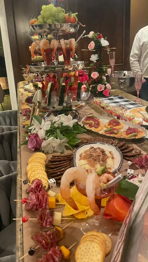 Grazing table styled for a casino game night with charcuterie and shrimp cocktail
