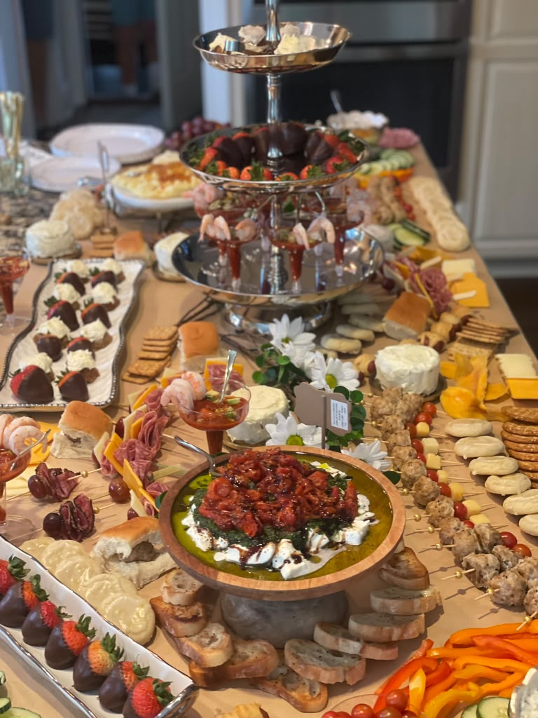 Grazing table with tiered display, chocolate strawberries and cheeses